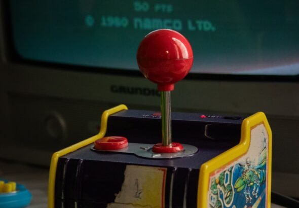 Compact retro gaming handheld with vertical form factor and D-pad