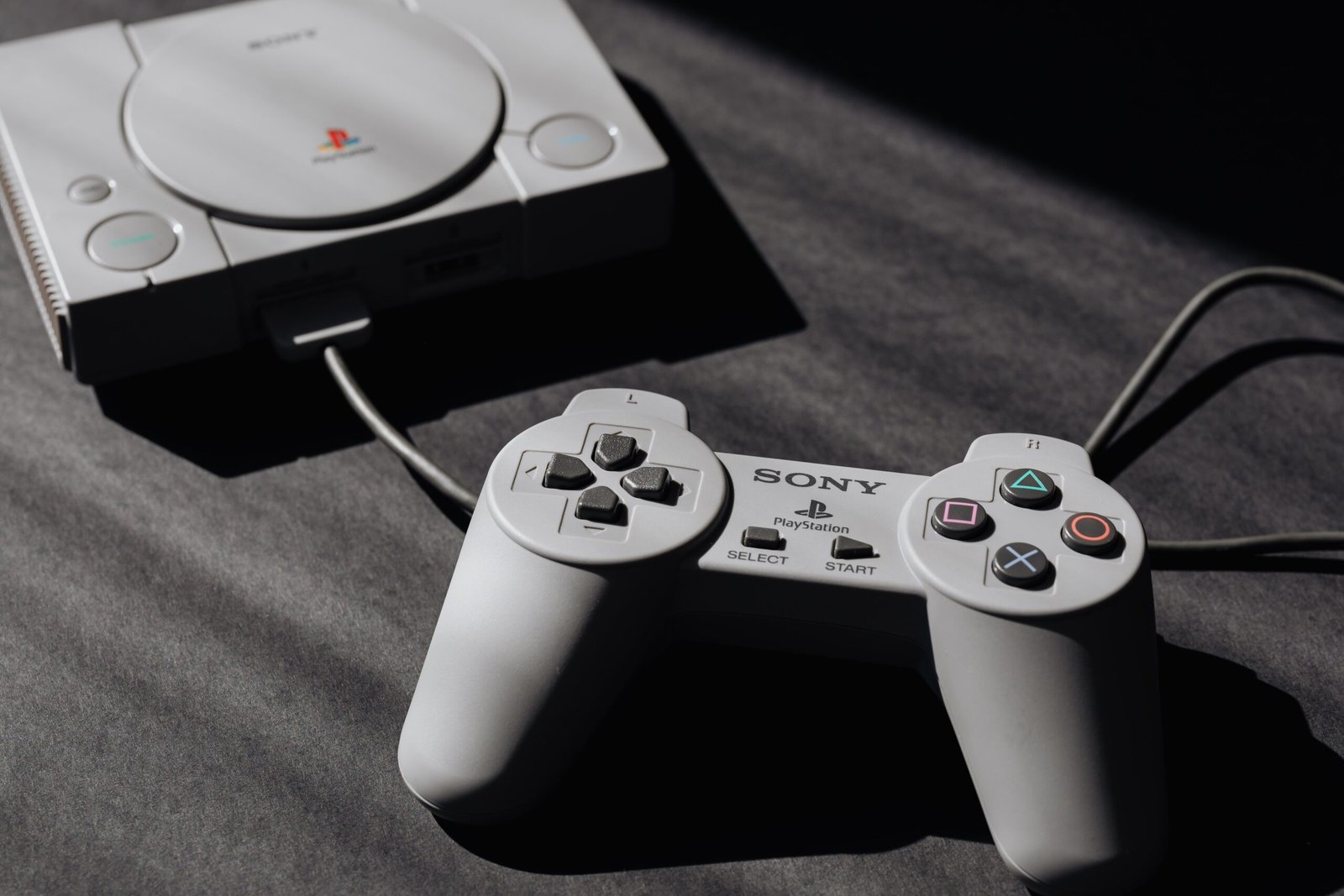 Retro Sony PlayStation console with classic controller