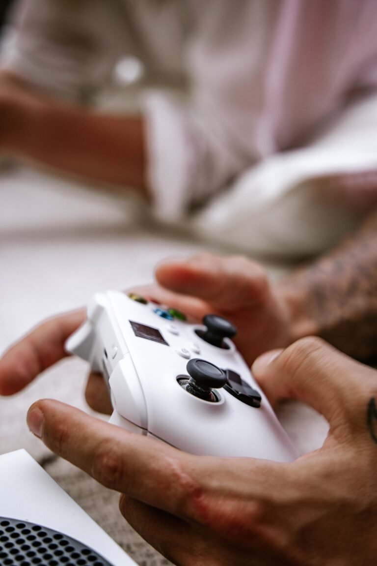 Close-up of hands holding a game controller with thumbs on the analog sticks