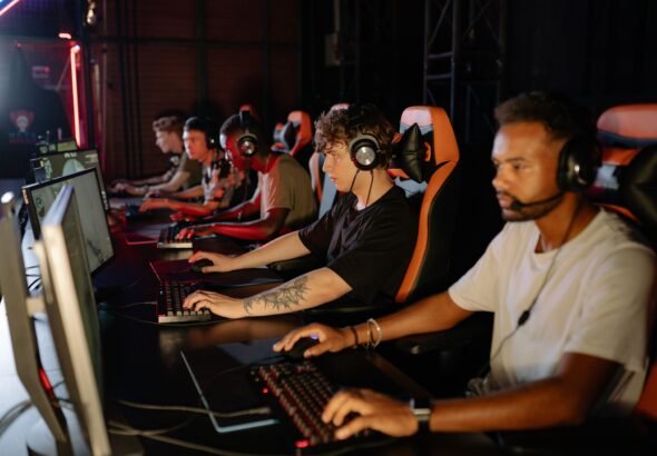 Group of young esports players competing seriously in a tournament setting