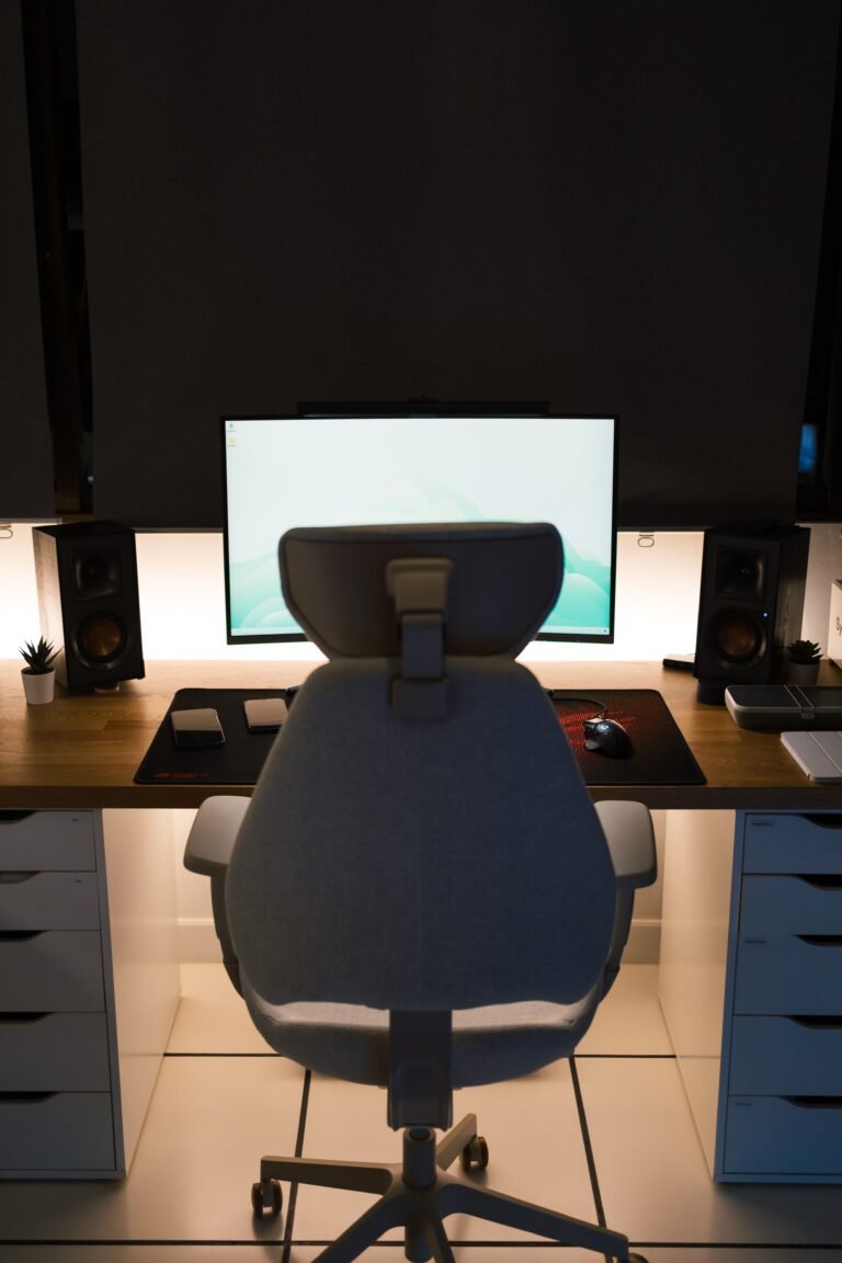 Modern ergonomic office chair beside a desk with computer setup