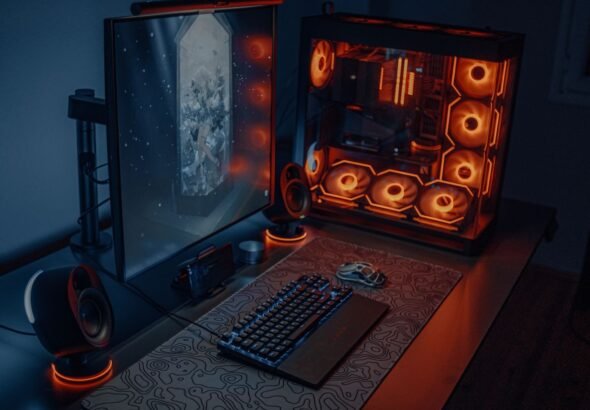 Modern gaming desk and chair setup with RGB lighting and dual monitors