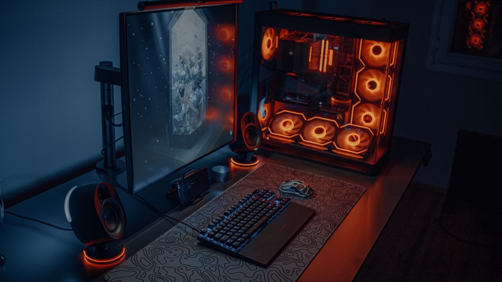 Modern gaming desk and chair setup with RGB lighting and dual monitors