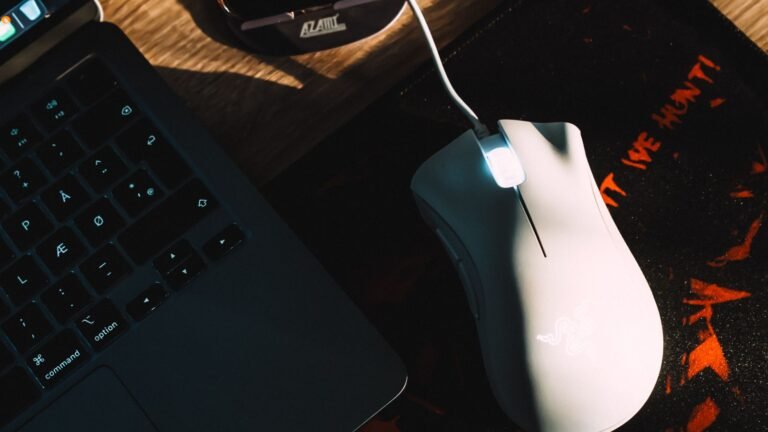 Gaming laptop on a desk with RGB keyboard lighting