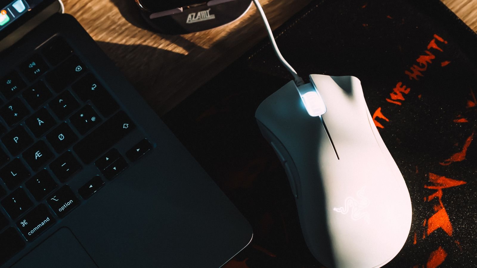 Gaming laptop on a desk with RGB keyboard lighting