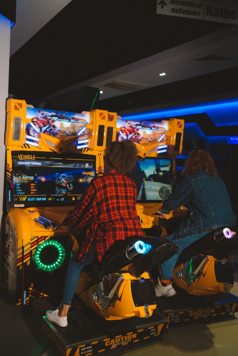 Two people playing a competitive arcade game together