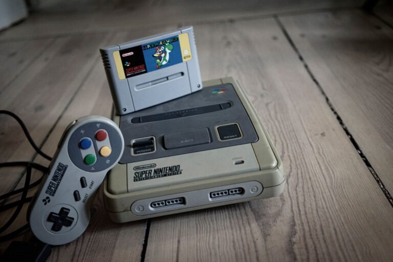 Vintage Super Nintendo style retro console and controller on wooden floor
