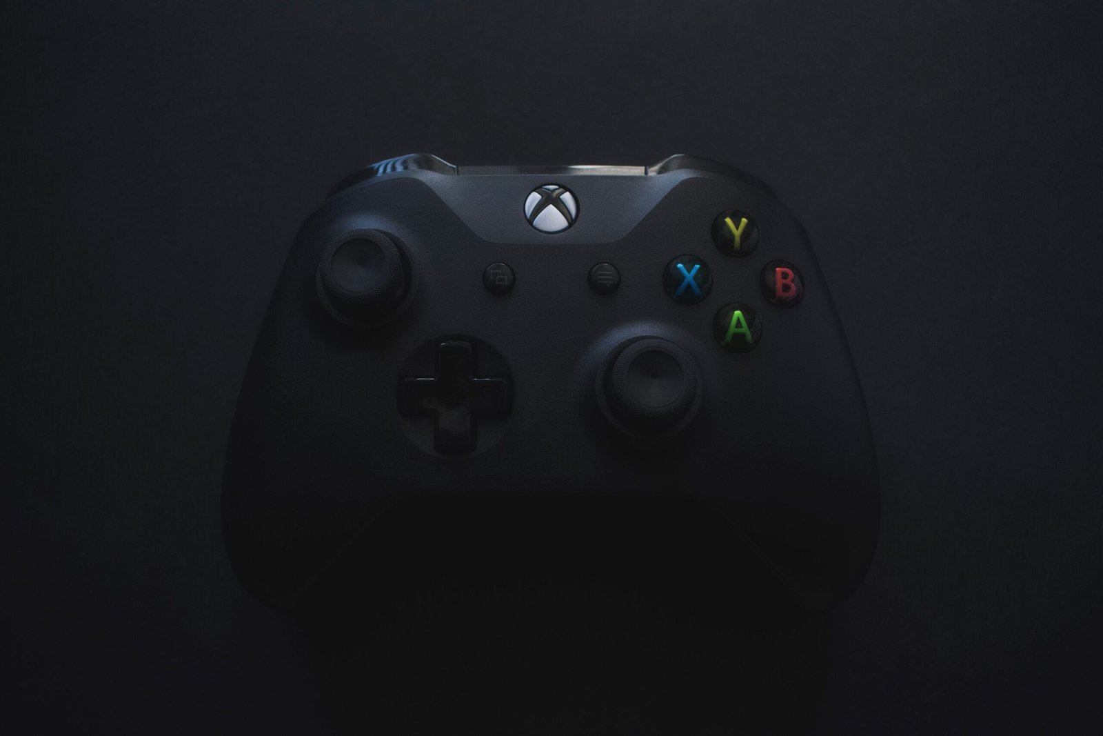 Xbox controller illuminated against a dark background
