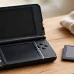 Nintendo 3DS handheld console next to a Nintendo DS game cartridge showing backwards compatibility